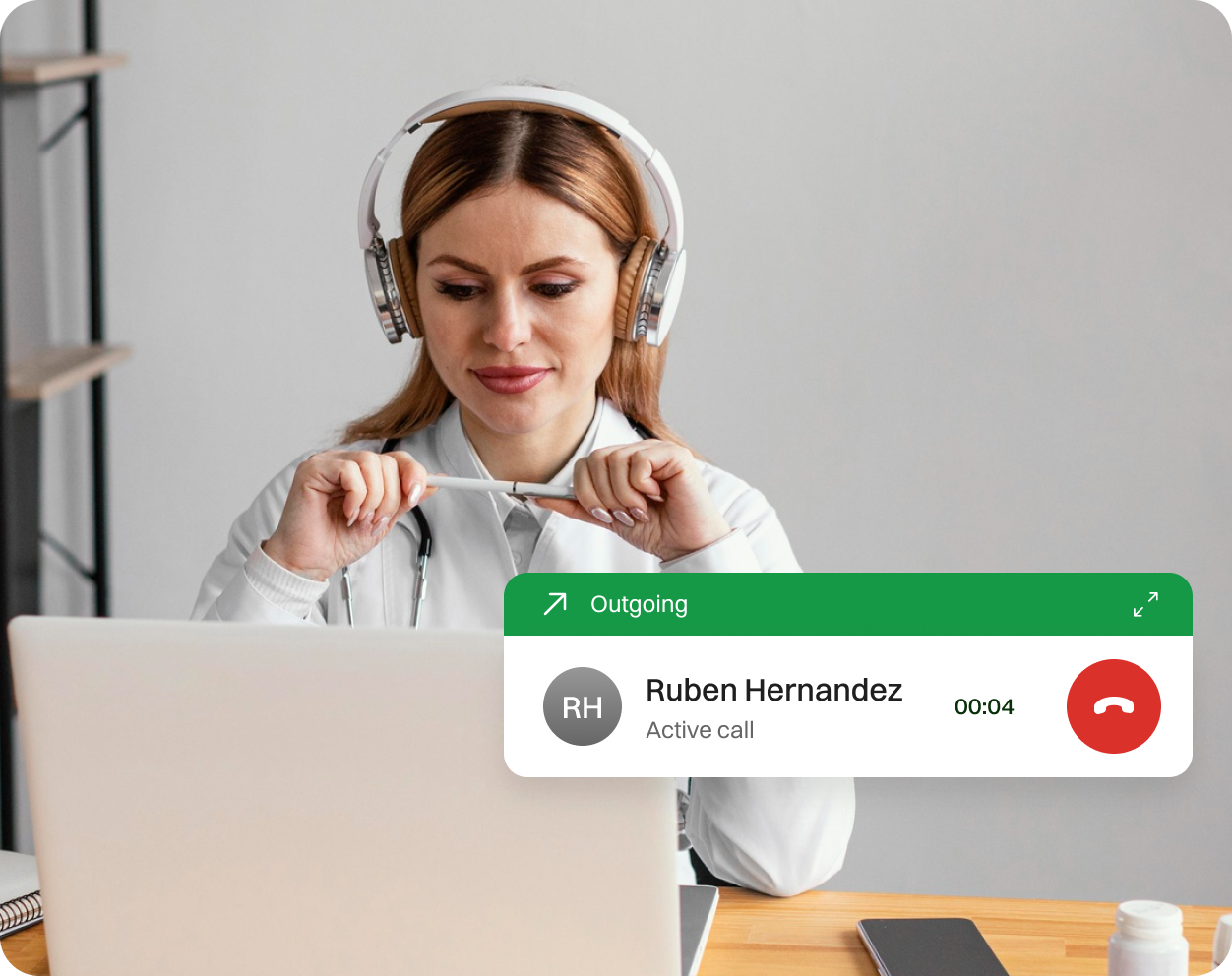 Girl in a call in a PC with client after getting notification from a mobile.